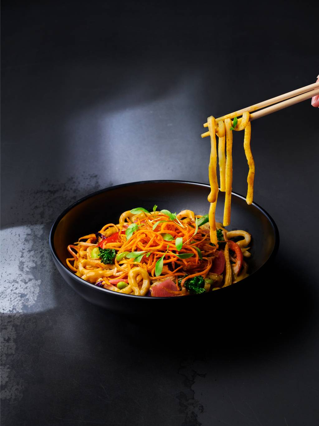 bowl of katsu with udon noodles and chopsticks